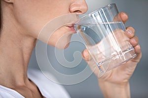 Healthy lady enjoying daily morning habit, sipping aqua.