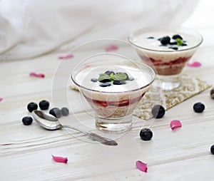 Healthy layered dessert with cream, strawberries and blueberries