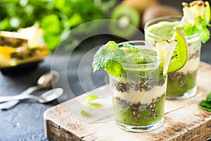 Healthy layered smoothie with kiwi, pineapple, chia