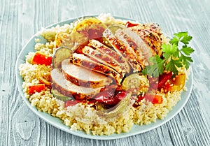 Healthy lean grilled chicken breast on couscous