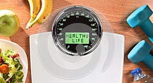 Healthy life background with weighing scale with message and objects