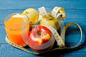 Healthy lifestyle. Apple and orange juice on a wooden background
