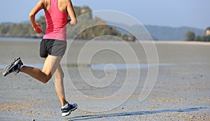 healthy lifestyle asian woman running on beach