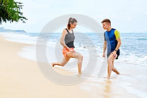 Healthy Lifestyle. Athlete Stretching, Exercising On Beach. Fitness, Athletics, Sports