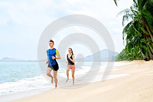 Healthy Lifestyle. Athletic Couple Running On Beach. Sports, Fit