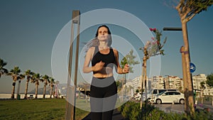 Healthy lifestyle beautiful Asian woman running at sunrise seaside.