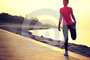 Healthy lifestyle beautiful asian woman stretching legs before running