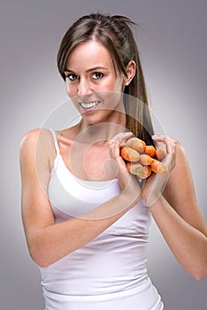 Healthy lifestyle! Beautiful woman holding lots of carrots heart shape