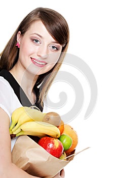 Healthy lifestyle - cheerful woman with fruit shopping paper bag