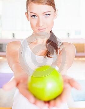 Healthy lifestyle concept with beautiful woman holding green apple