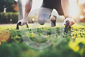 Healthy lifestyle concept.Male athlete exercising push up outside in sunny park. Fit shirtless male fitness model in