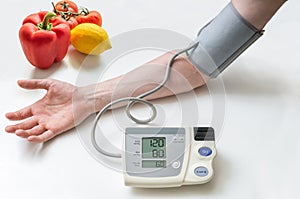 Healthy lifestyle concept. Man is measuring blood pressure with m