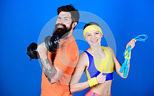 Healthy lifestyle concept. Man and woman exercising with dumbbell and jumping rope. Fitness exercises. Workout and