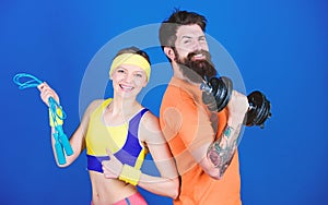 Healthy lifestyle concept. Man and woman exercising with dumbbell and jumping rope. Fitness exercises. Workout and