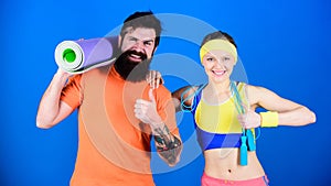 Healthy lifestyle concept. Man and woman exercising with yoga mat and jump rope. Fitness exercises. Workout and fitness