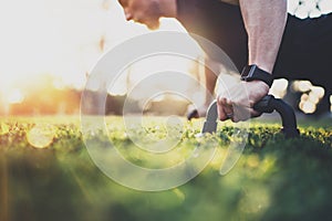 Healthy lifestyle concept.Muscular athlete exercising push up outside in sunny park. Fit shirtless male fitness model in