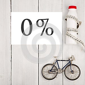 Healthy lifestyle concept, sport and diet - bicycle model, bottle of water, centimeter tape and text 0% percent