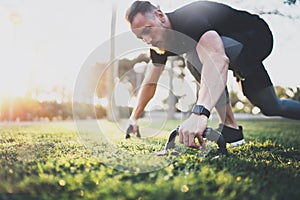 Healthy lifestyle concept.Young athlete exercising push up outside in sunny park. Fit shirtless male fitness model in