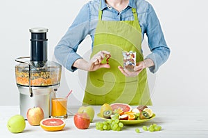 Healthy lifestyle and diet concept. Fruit juice, pills and vitamin supplements, woman making a choice