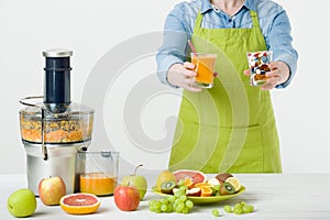 Healthy lifestyle and diet concept. Fruit juice, pills and vitamin supplements, woman making a choice