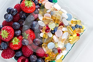 Healthy lifestyle, diet concept, Fruit and pills, vitamin supplements with on white background.