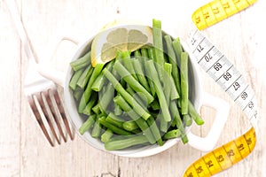 healthy lifestyle or eating- green bean with meter tape