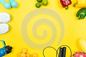 Healthy lifestyle, food and sport concept. athlete`s equipment and fresh fruit and vegetable on yellow background