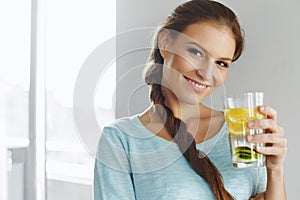 Healthy Lifestyle And Food. Woman Drinking Fruit Water. Detox. H