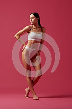 Healthy lifestyle. Full-length image of beautiful young woman with slim, fit body shape standing in white cotton