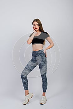 Healthy lifestyle: full length portrait of smiling young fitness girl in perfect shape, studio shot, white background