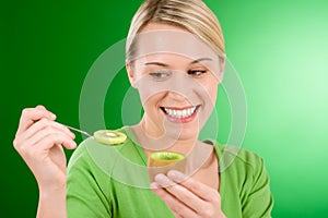 Healthy lifestyle - happy woman holding kiwi