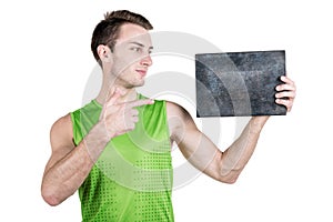 Healthy lifestyle. Portrait of a handsome guy with an empty signboard for writing, wearing sportswear, isolated on white backgroun