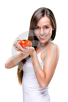 Healthy lifestyle! Pretty woman holding a tomato