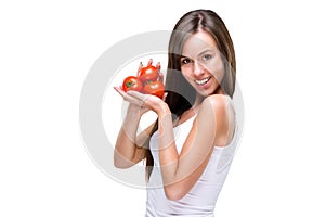 Healthy lifestyle! Pretty woman holding a tomato