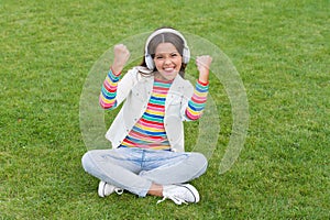 Healthy lifestyle and relax. Yoga girl. small kid in headphones. summer playlist. enjoy spring nature outdoor. child