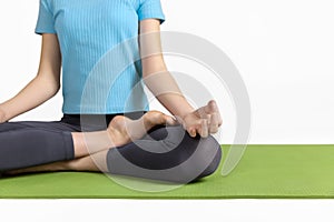 Healthy lifestyle. Relaxation wellness meditation Portrait of teenage girl practicing yoga meditation exercise on green rug.