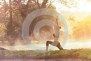 Healthy Lifestyle. Silhouette meditation yoga woman for relax vital and energy in the morning at the hot spring park.