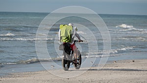 Healthy lifestyle, sport. Riding a bike on the beach