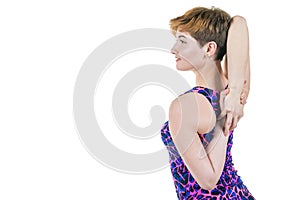 Healthy lifestyle, sport. Young girl kneads hands and shoulders, on a white background. Horizontal frame