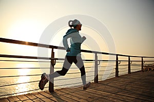 Healthy lifestyle sports woman running on unrise seaside