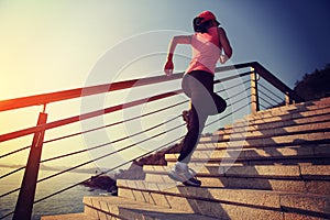 Healthy lifestyle sports woman running up on stone stairs