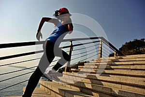 Healthy lifestyle sports woman running up on stone stairs sunrise