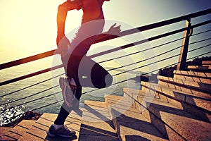 Healthy lifestyle sports woman running up on stone stairs sunrise