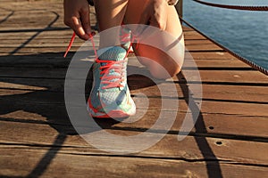Healthy lifestyle sports woman tying shoelaces