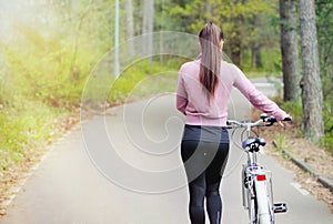 Healthy lifestyle sporty woman on bike in forest