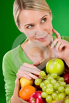 Healthy lifestyle - thoughtful woman with fruit