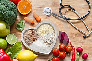 Healthy lifestyle with vegetarian food in heart and stethoscope alternative medicine concept