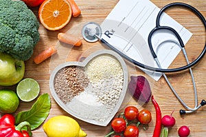 Healthy lifestyle with vegetarian food in heart and stethoscope alternative medicine concept