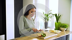 Healthy Lifestyle. Woman Cutting Fresh Fruits At Kitchen