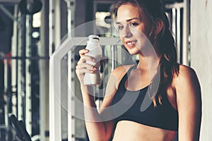 Healthy lifestyle woman drink protein at fitness gym.  Young people girl workout exercise body